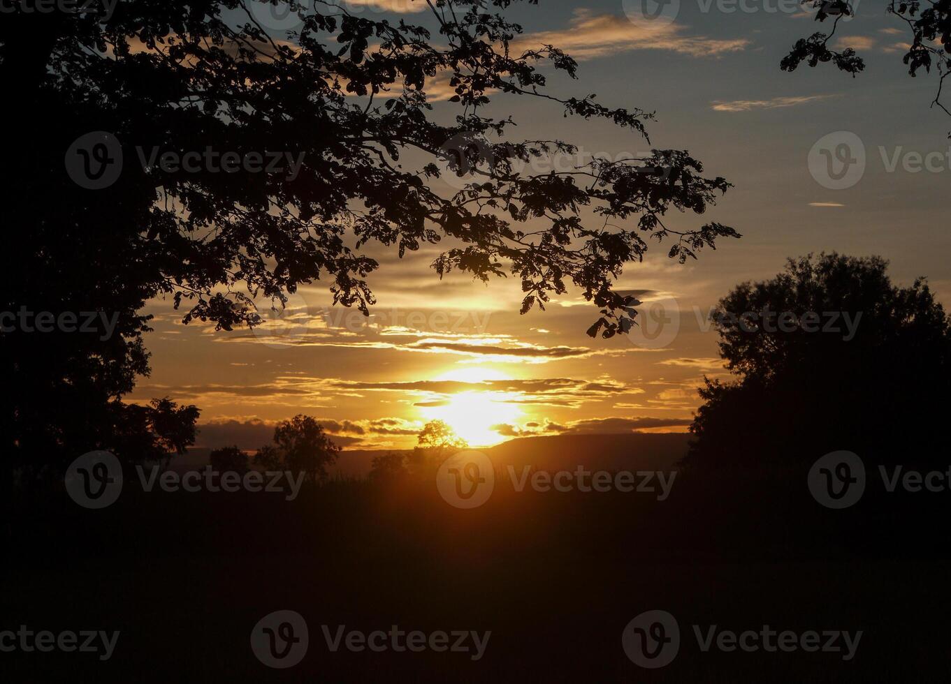 Spectacular sunset over, orange sun rising up over the horizon photo