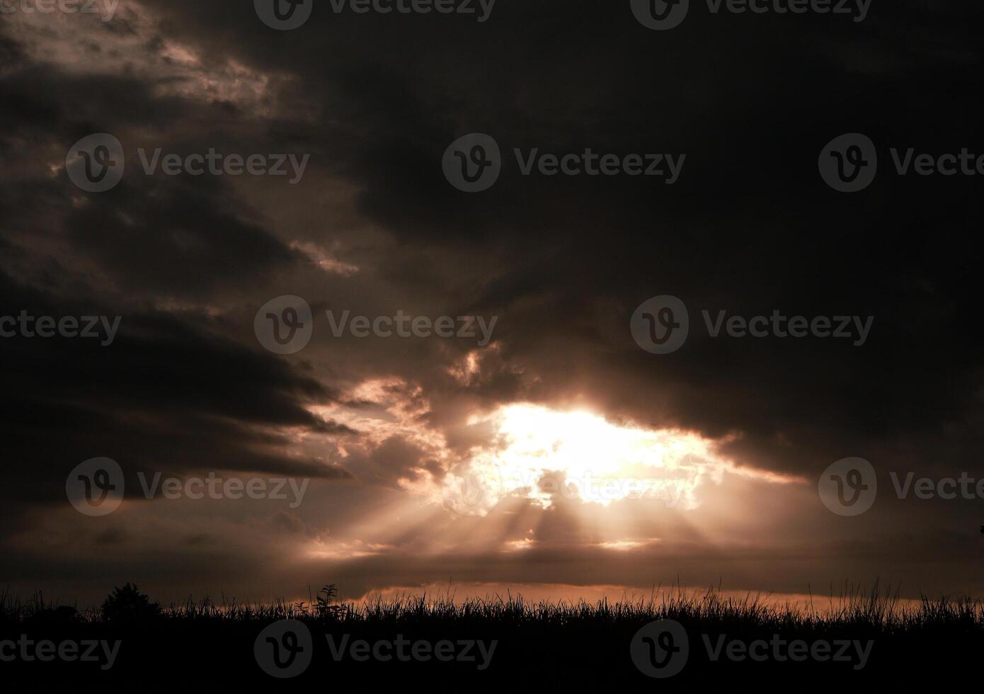 Spectacular sunset over, orange sun rising up over the horizon photo