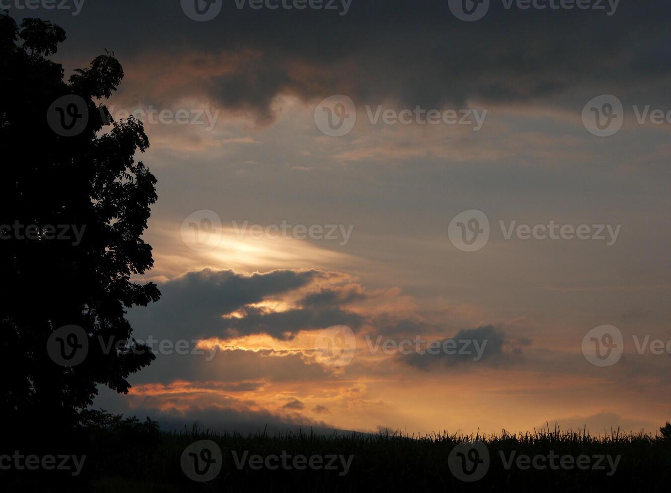 Spectacular sunset over, orange sun rising up over the horizon photo