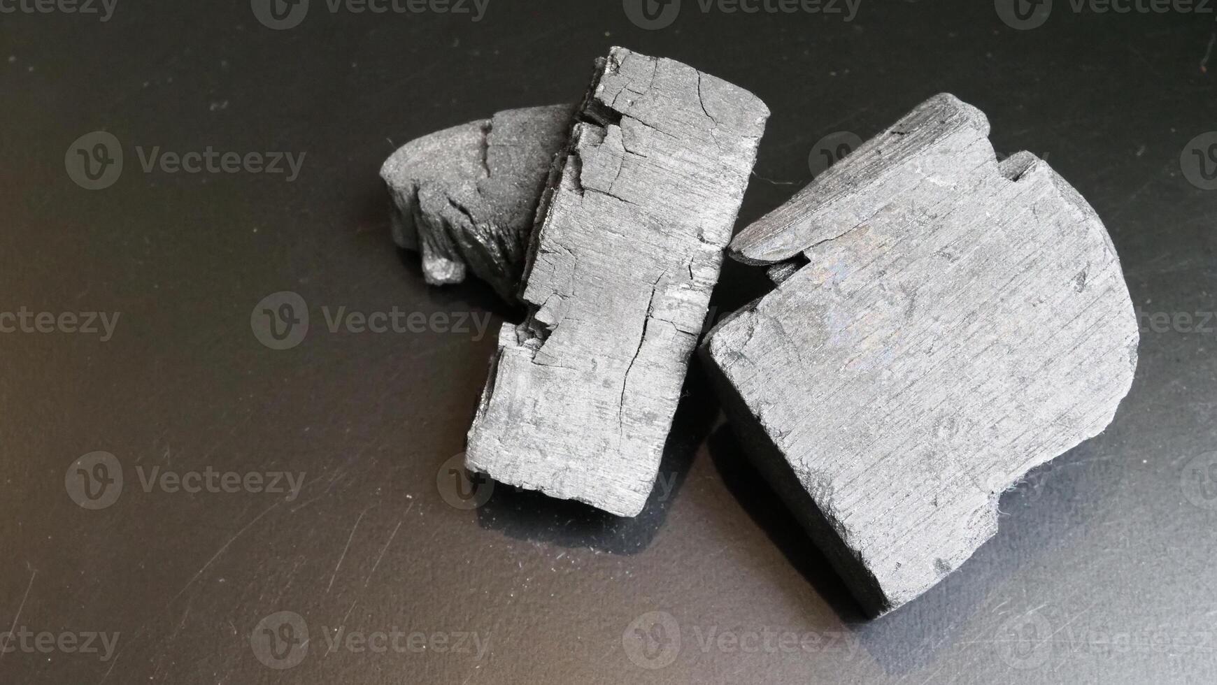 Natural wood charcoal traditional charcoal or hard wood charcoal on wooden table top view. photo