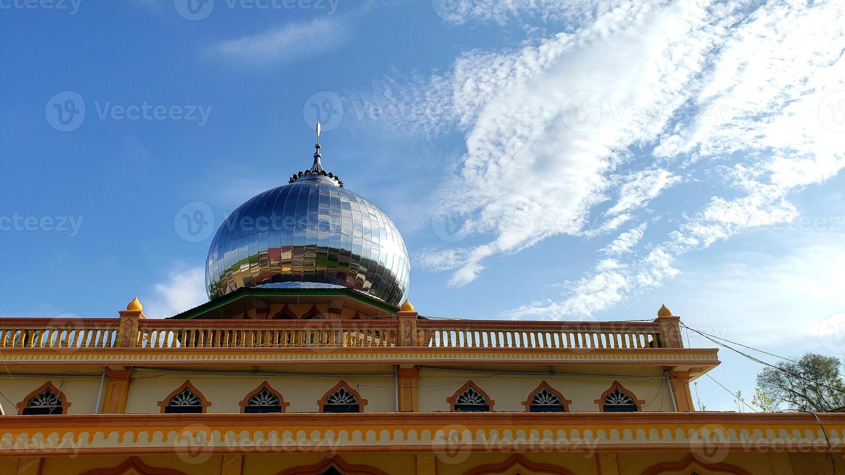 View of the mosque's transitional dome during the day with a cloudy sky in the background. Good for writing greetings and good for posting on social media photo