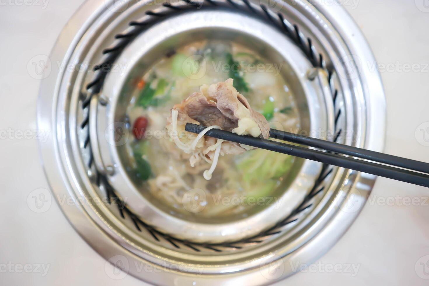 eating Sukiyaki ,suki or shabu pot photo