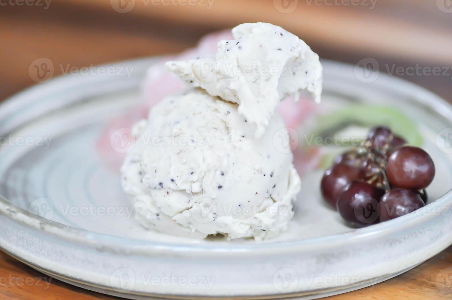 ice cream and fruit , vanilla ice cream or sesame ice cream with grape and kiwi fruit photo