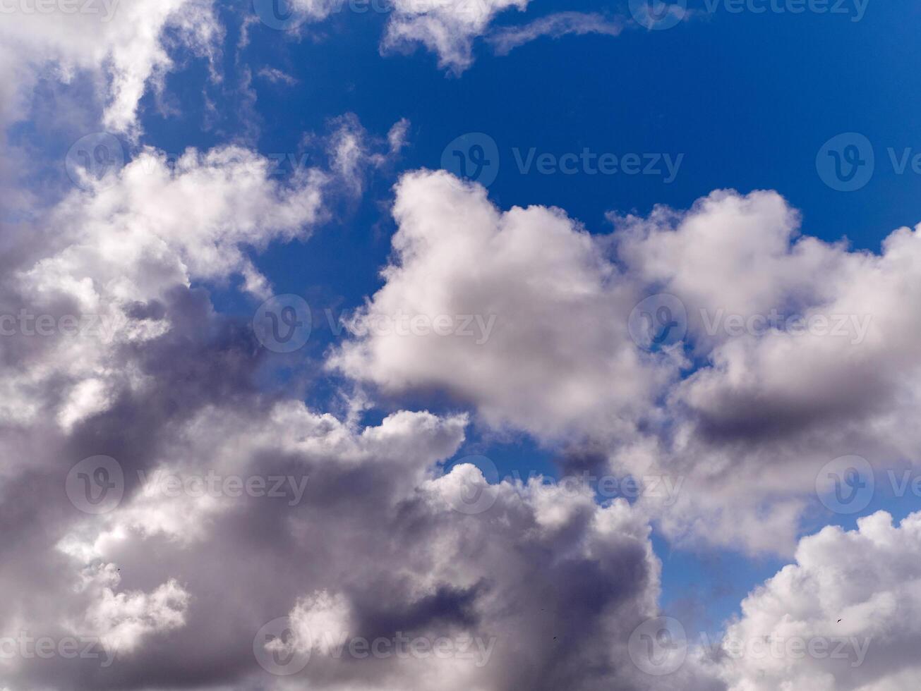 White fluffy cumulus clouds in the summer sky, natural clouds background photo