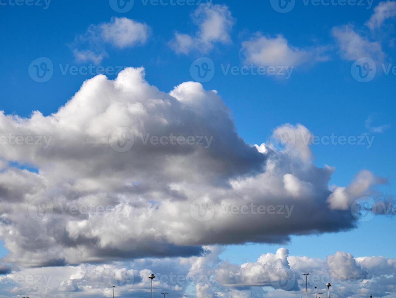 Cumulus clouds in the sky. Fluffy cloud shapes photo