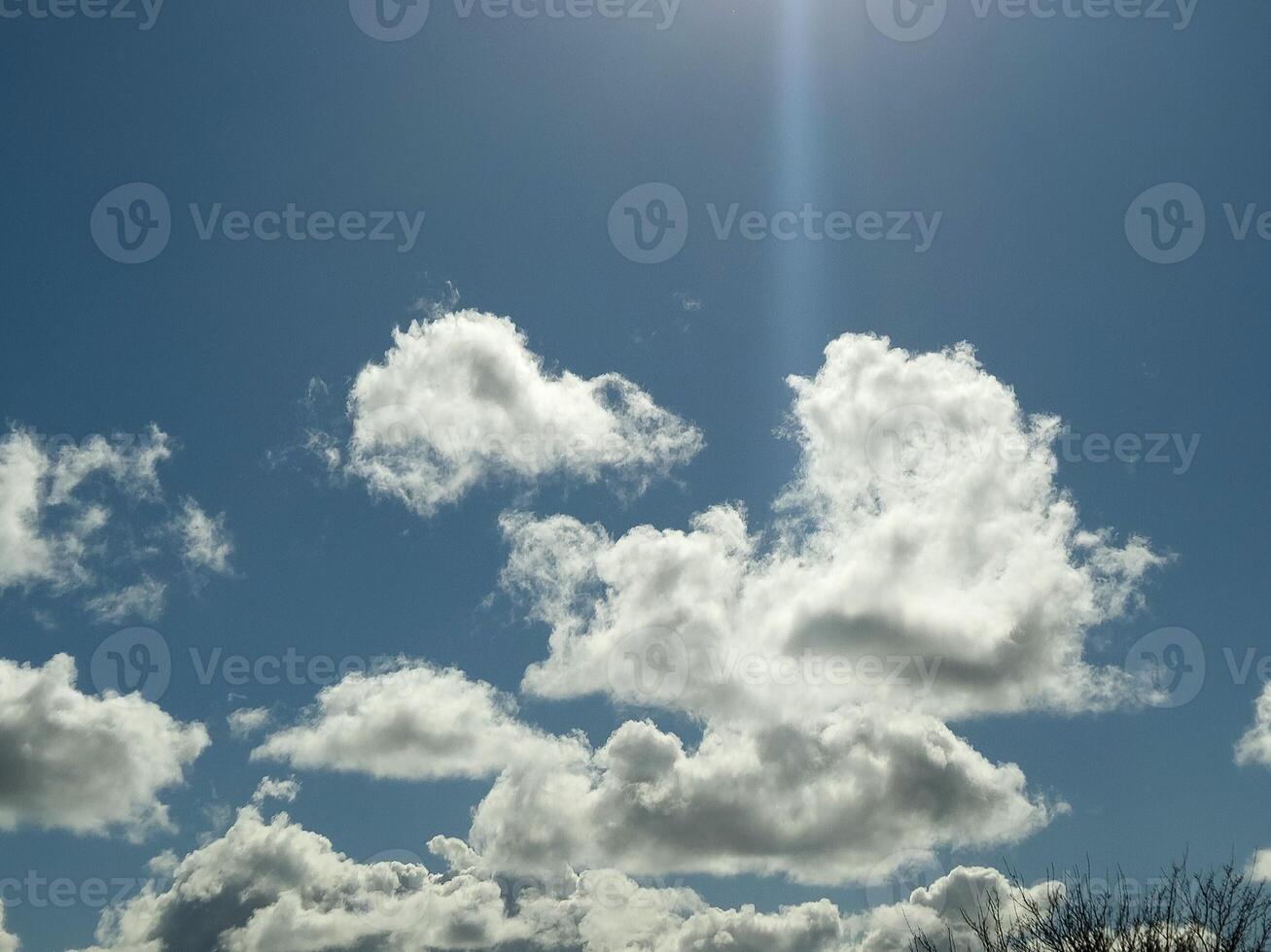 White fluffy cumulus clouds in the summer sky, natural clouds background photo
