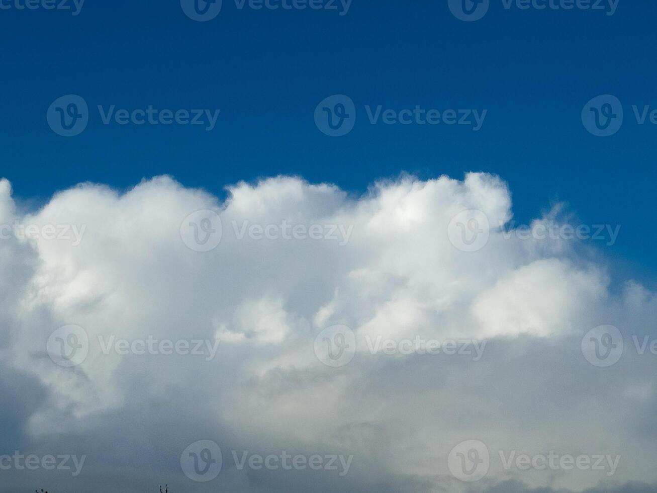 White fluffy cumulus clouds in the summer sky, natural clouds background photo