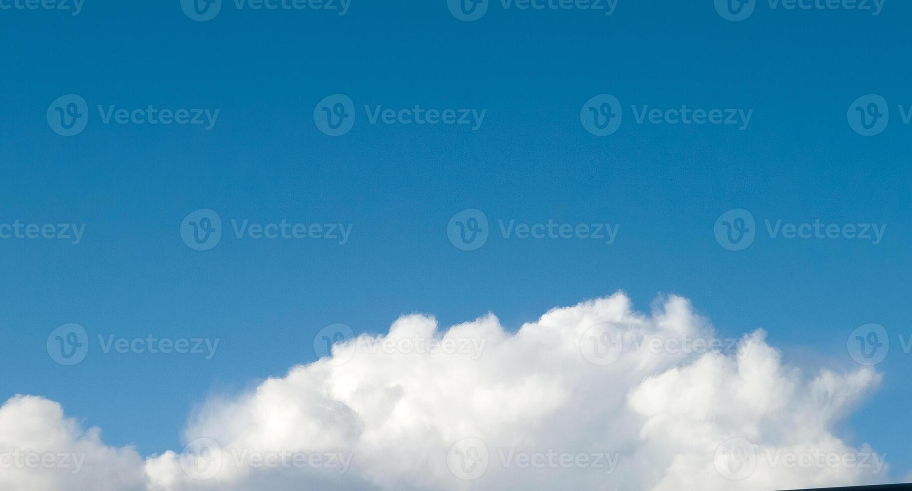 White fluffy cumulus clouds in the summer sky, natural clouds background photo