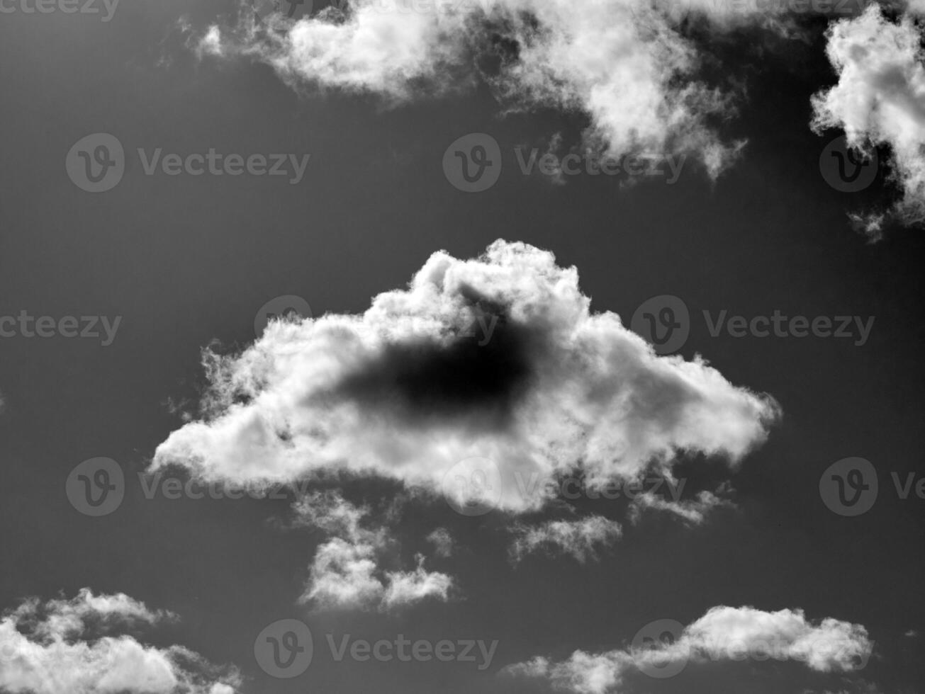 Black and white clouds in the sky background photo