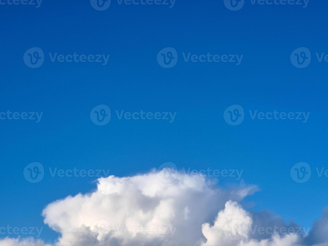 White fluffy cumulus clouds in the summer sky, natural clouds background photo