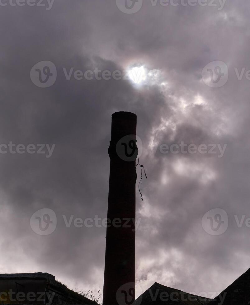 Industrial pipe and grey sky background, stormy sky wallpaper photo