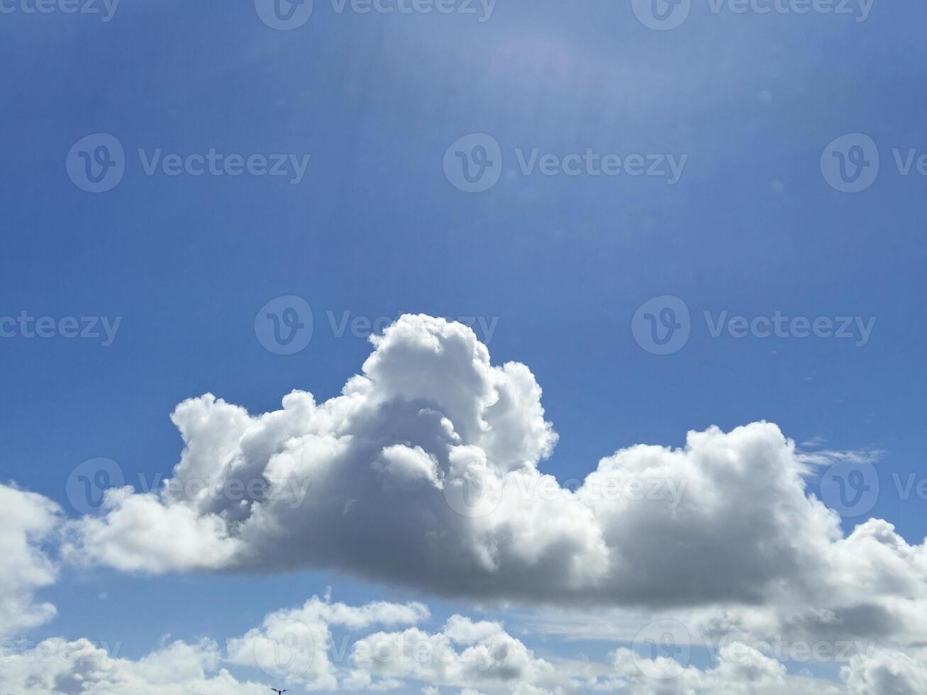 White fluffy cumulus clouds background. Summer clouds in the blue sky photo