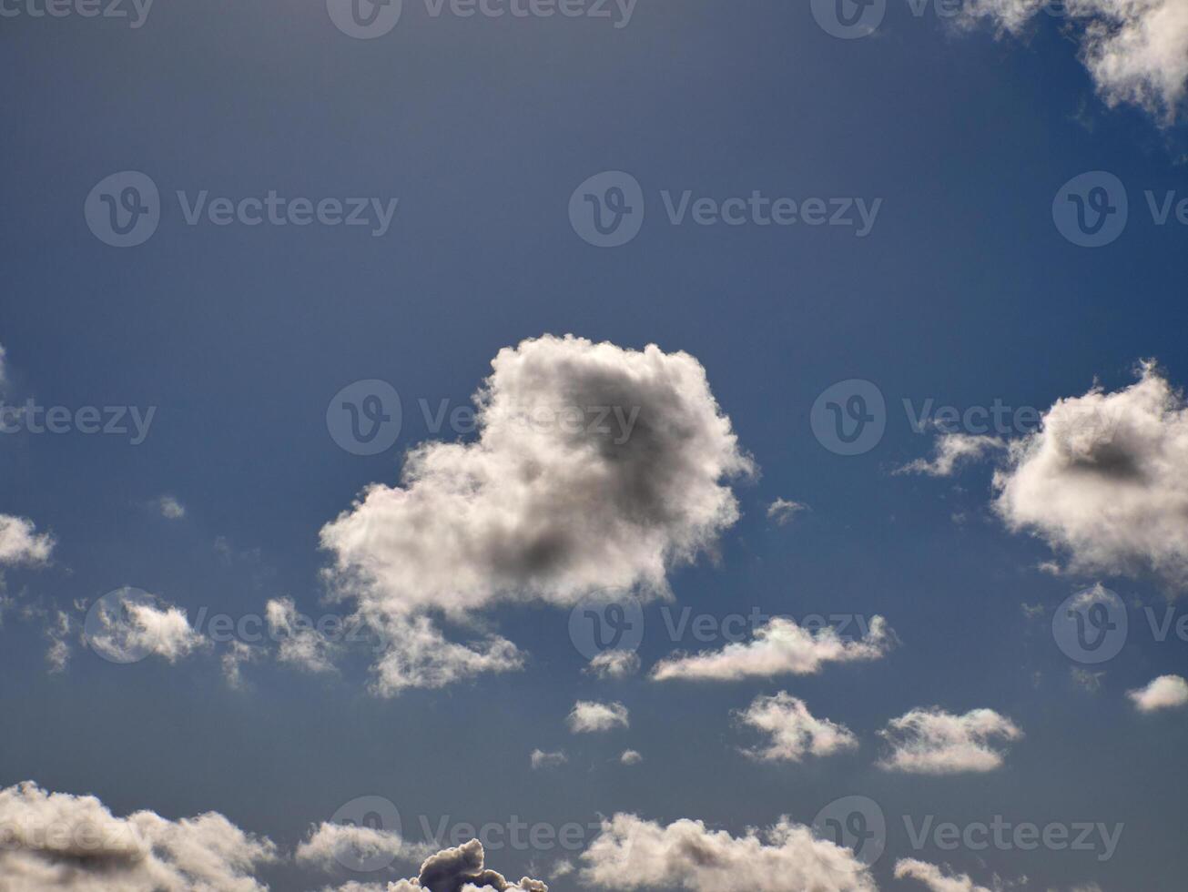 Cumulus clouds in the sky. Fluffy cloud shapes photo