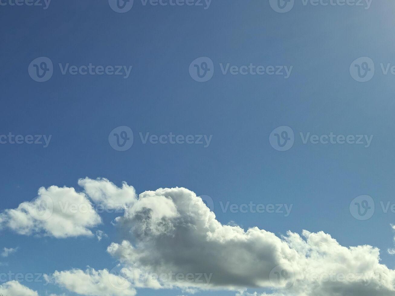 White fluffy cumulus clouds in the summer sky, natural clouds background photo