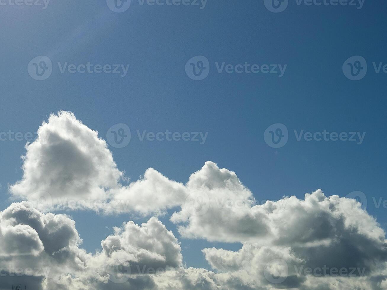 White fluffy cumulus clouds in the summer sky, natural clouds background photo