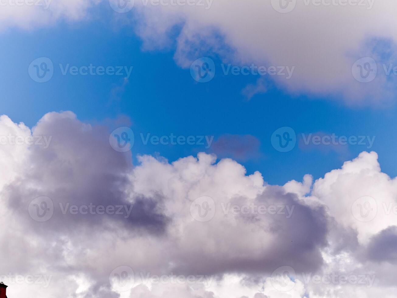 White fluffy cumulus clouds in the summer sky, natural clouds background photo