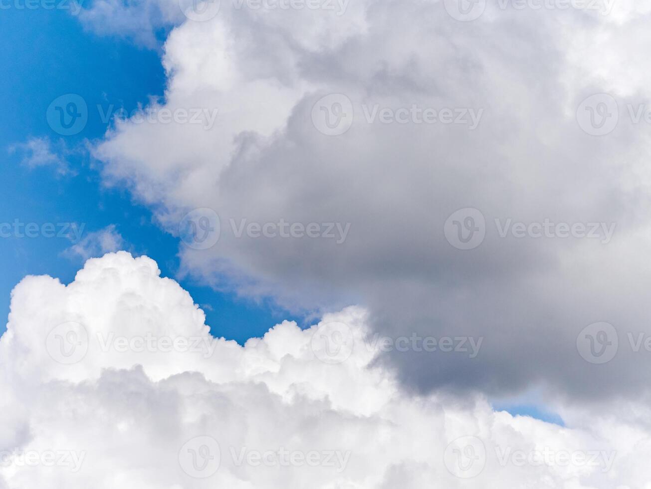 White fluffy cumulus clouds in the summer sky, natural clouds background photo