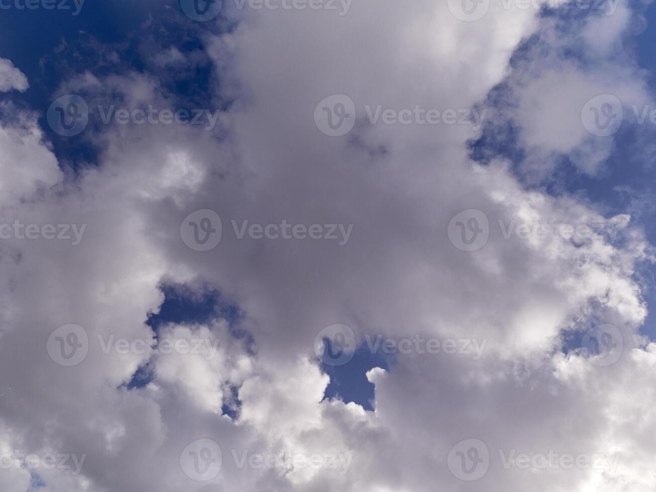 White fluffy cumulus clouds in the summer sky, natural clouds background photo