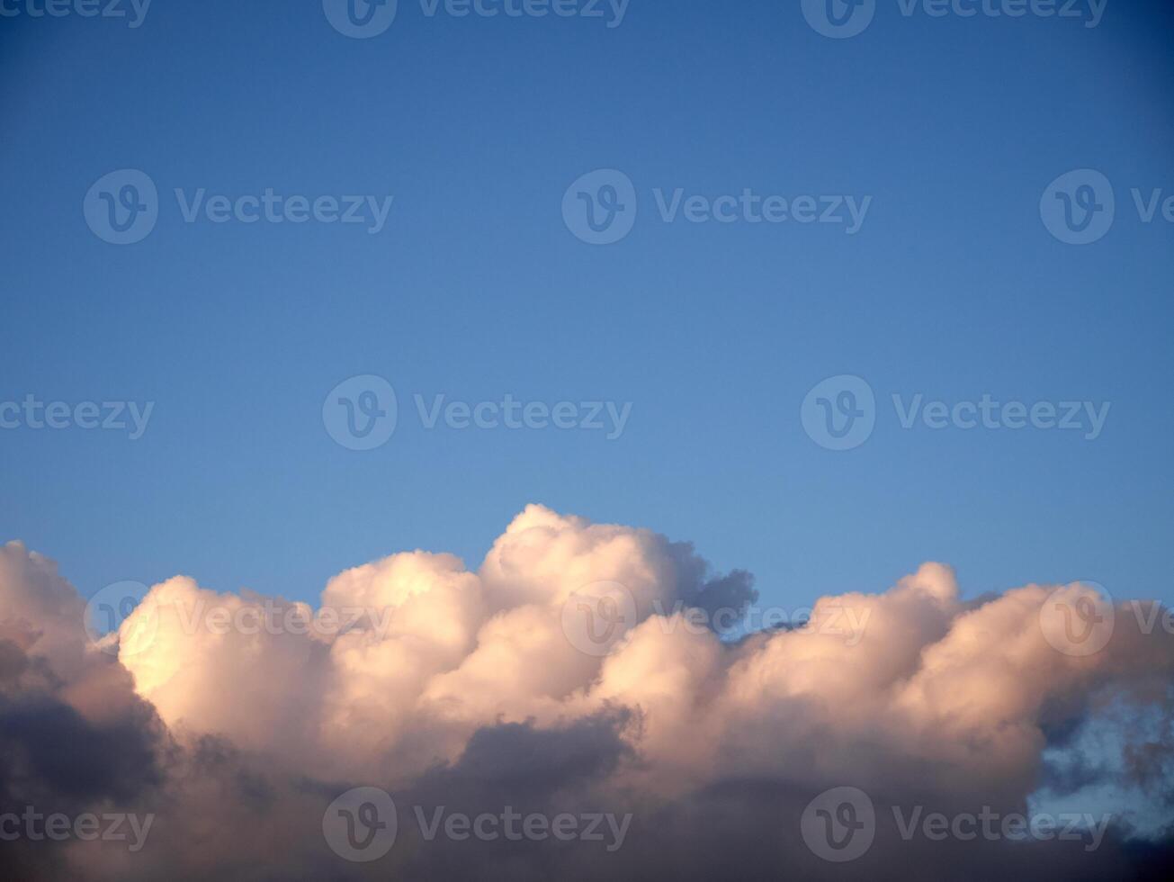 White fluffy cumulus clouds in the summer sky, natural clouds background photo