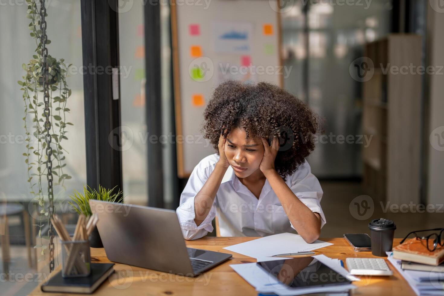 business woman sitting at work stressed , out working hard Feeling stressed out and dizzy from your job, work error photo