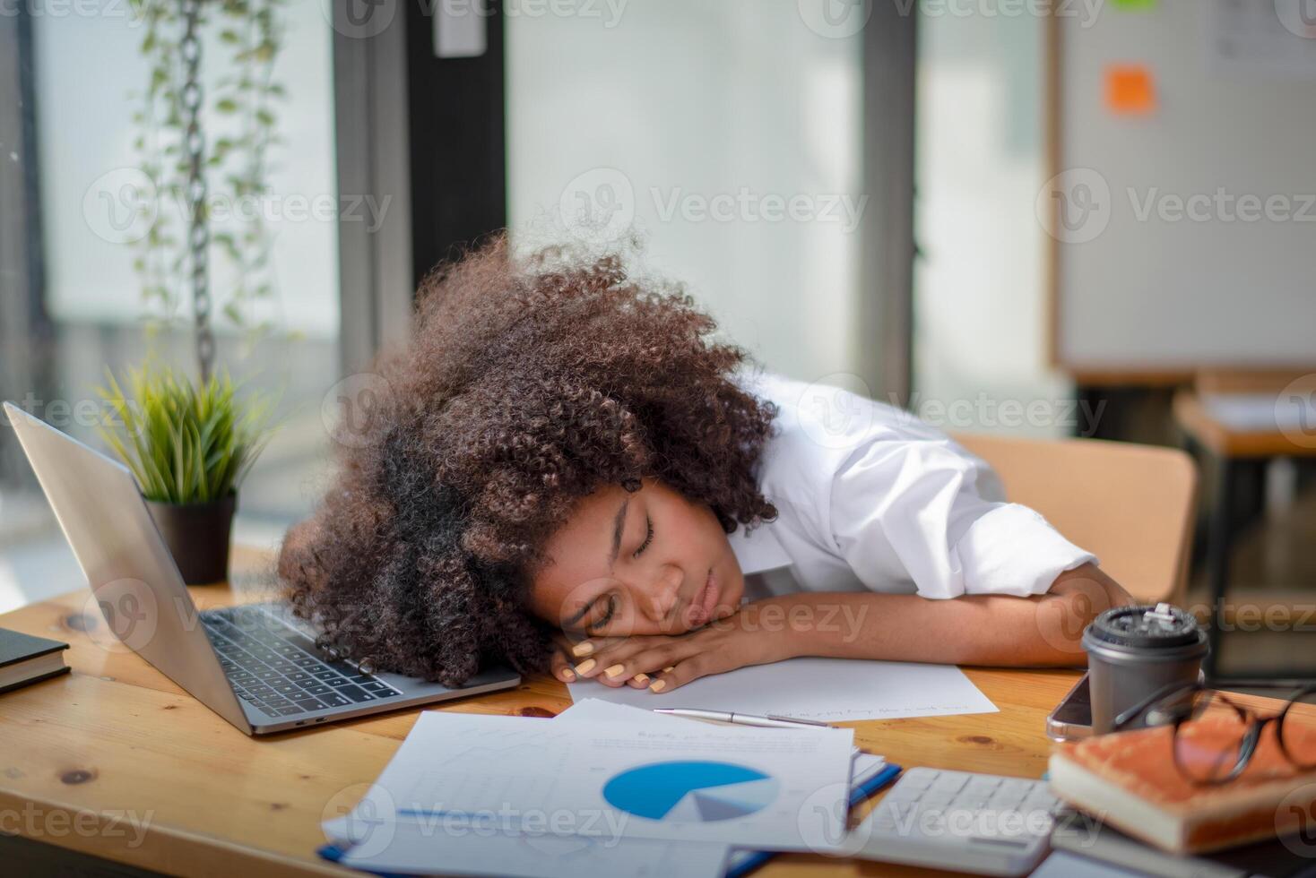 Businesswoman Falling a Sleep in an office, woman sleeping on laptop taking a power nap during work Isolated, taking a nap at the desk in the office. photo