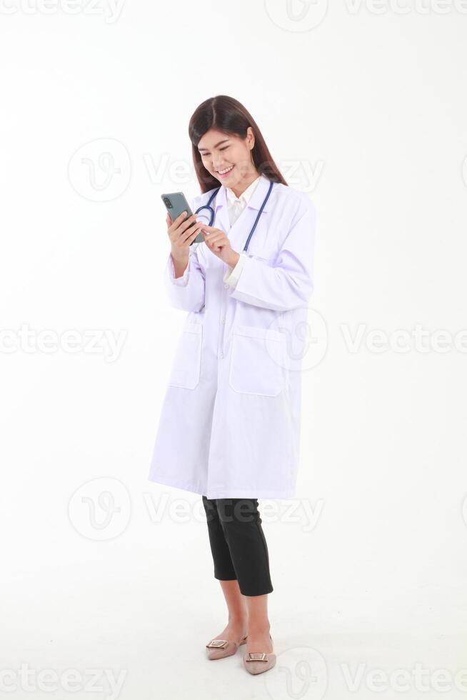 Asian female doctor holding a black smartphone online to talk to a patient to check for symptoms of illness. Medical service concept, social distancing to prevent coronavirus photo