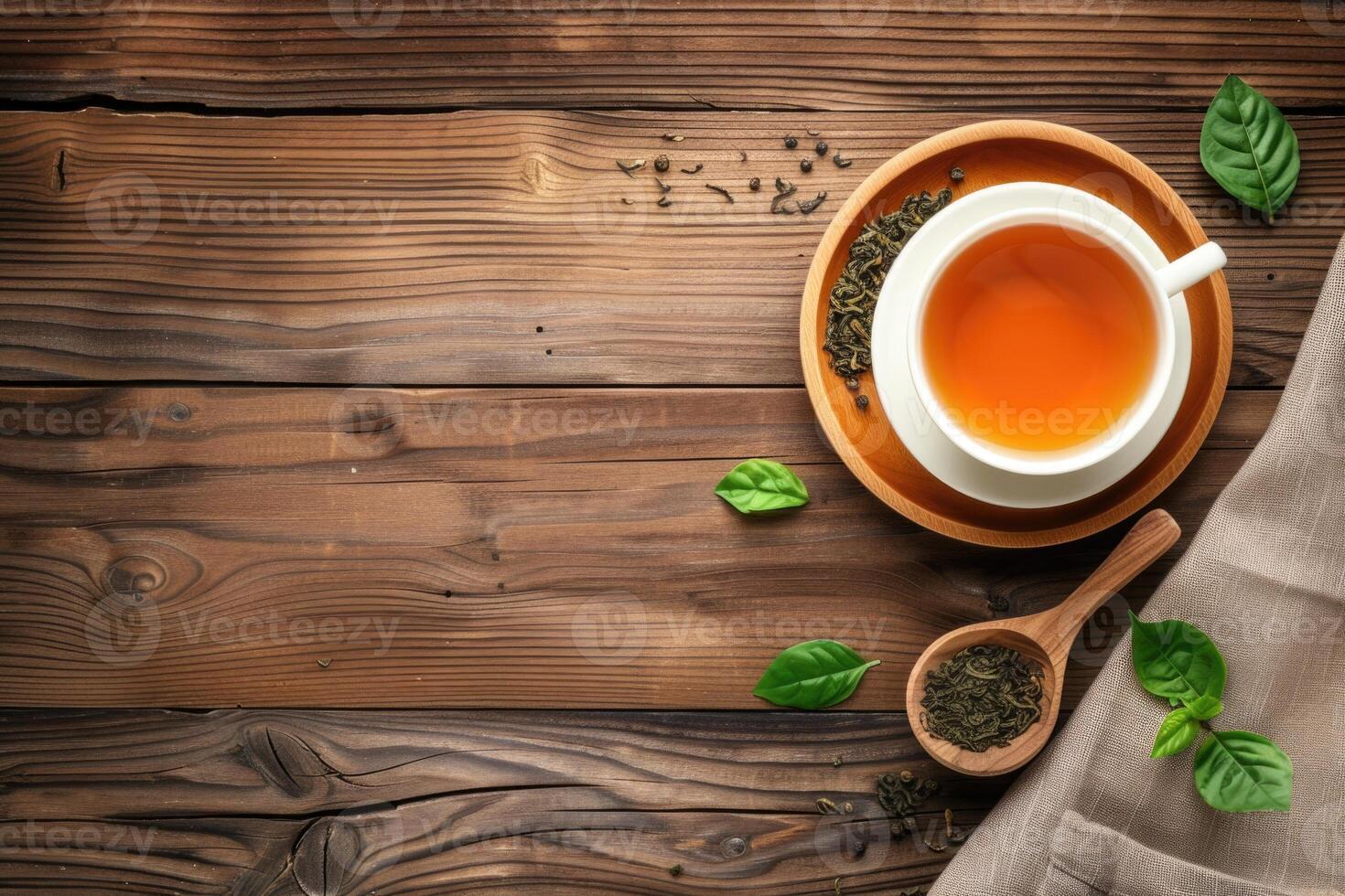 A cup of tea on a wooden background with tea tree petals. Tea party background with copy space photo