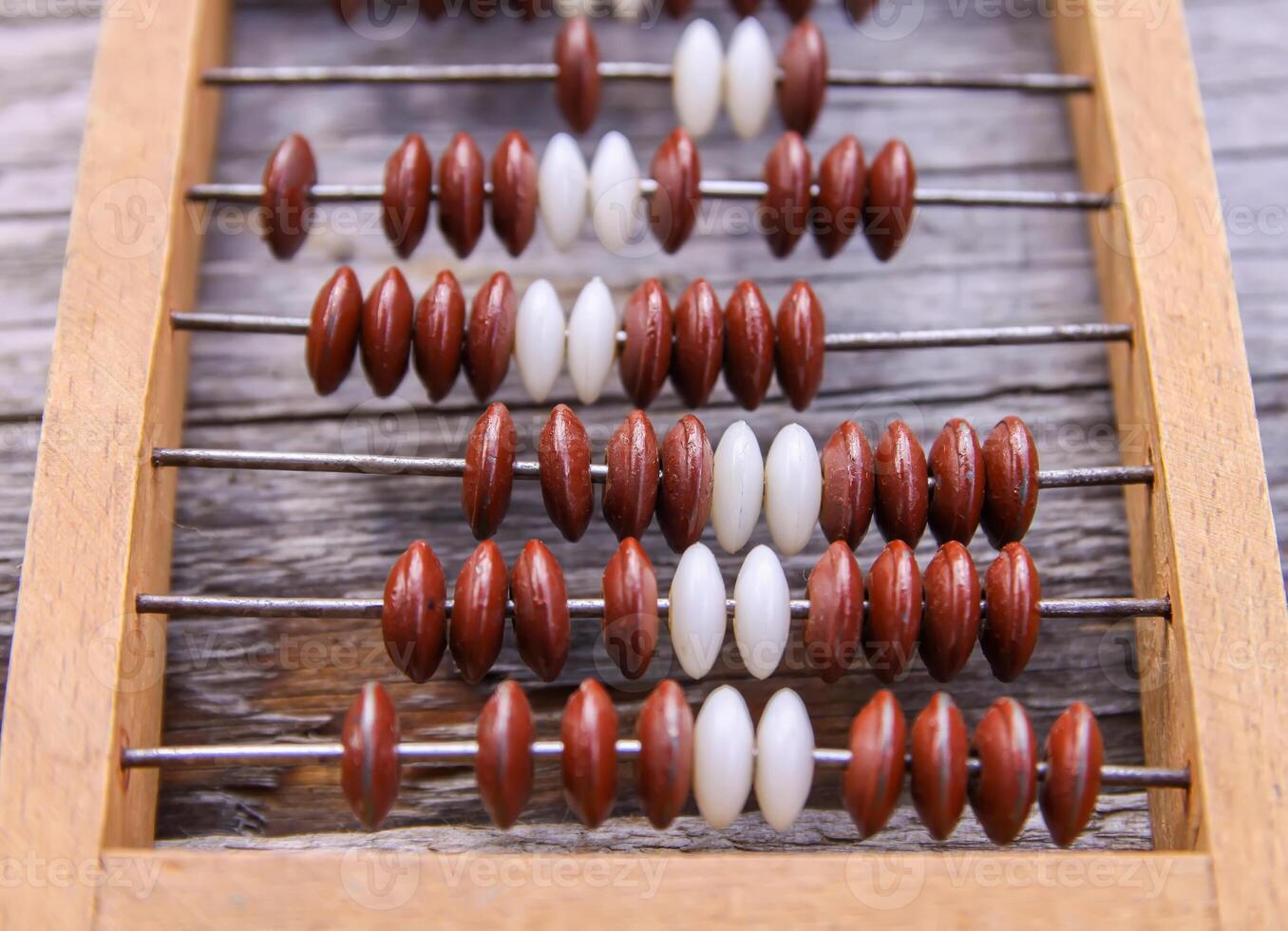 Vintage wooden abacus on old board surface. photo