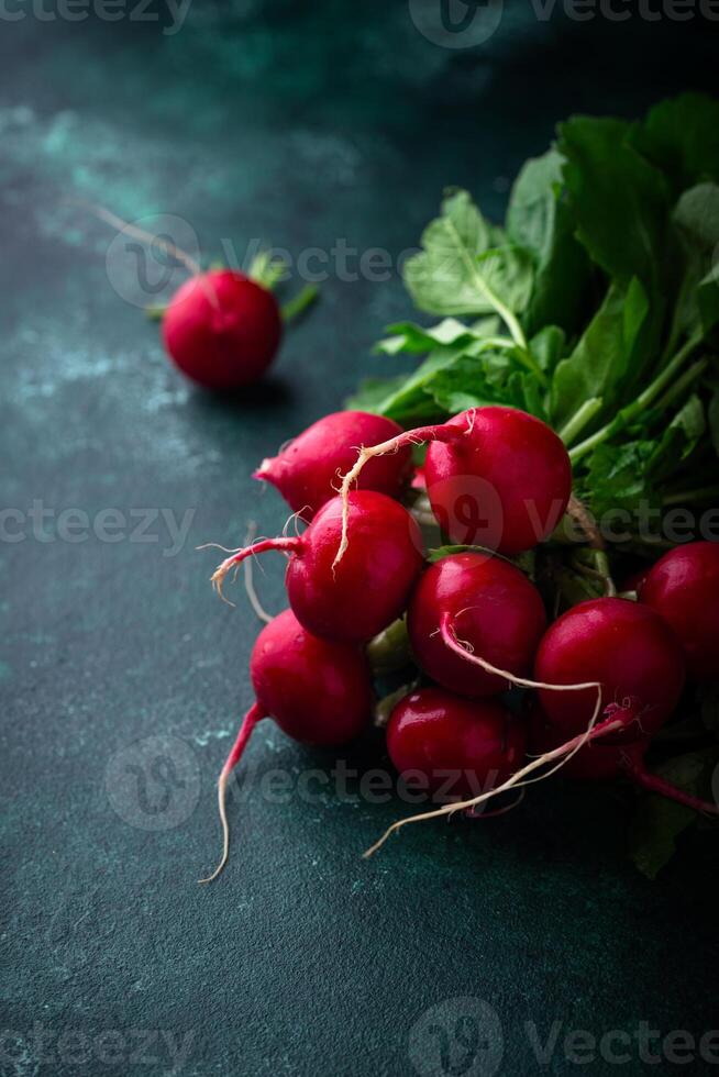 Fresh organic radish on green background photo