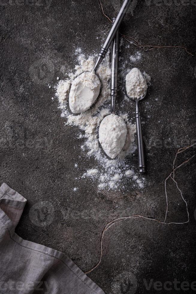 Wheat flour on dark. Baking background photo