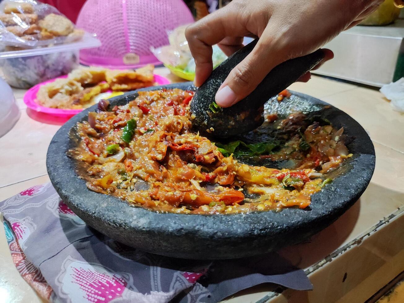 The spices will be crushed so that they become smooth and even. then it becomes sambal photo