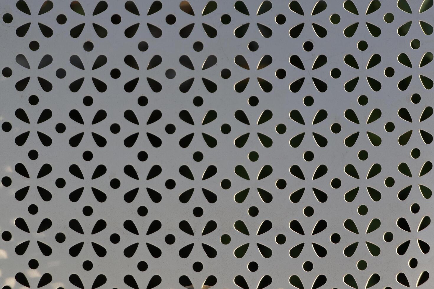 Close-up of a white chair with a floral pattern on the back. photo