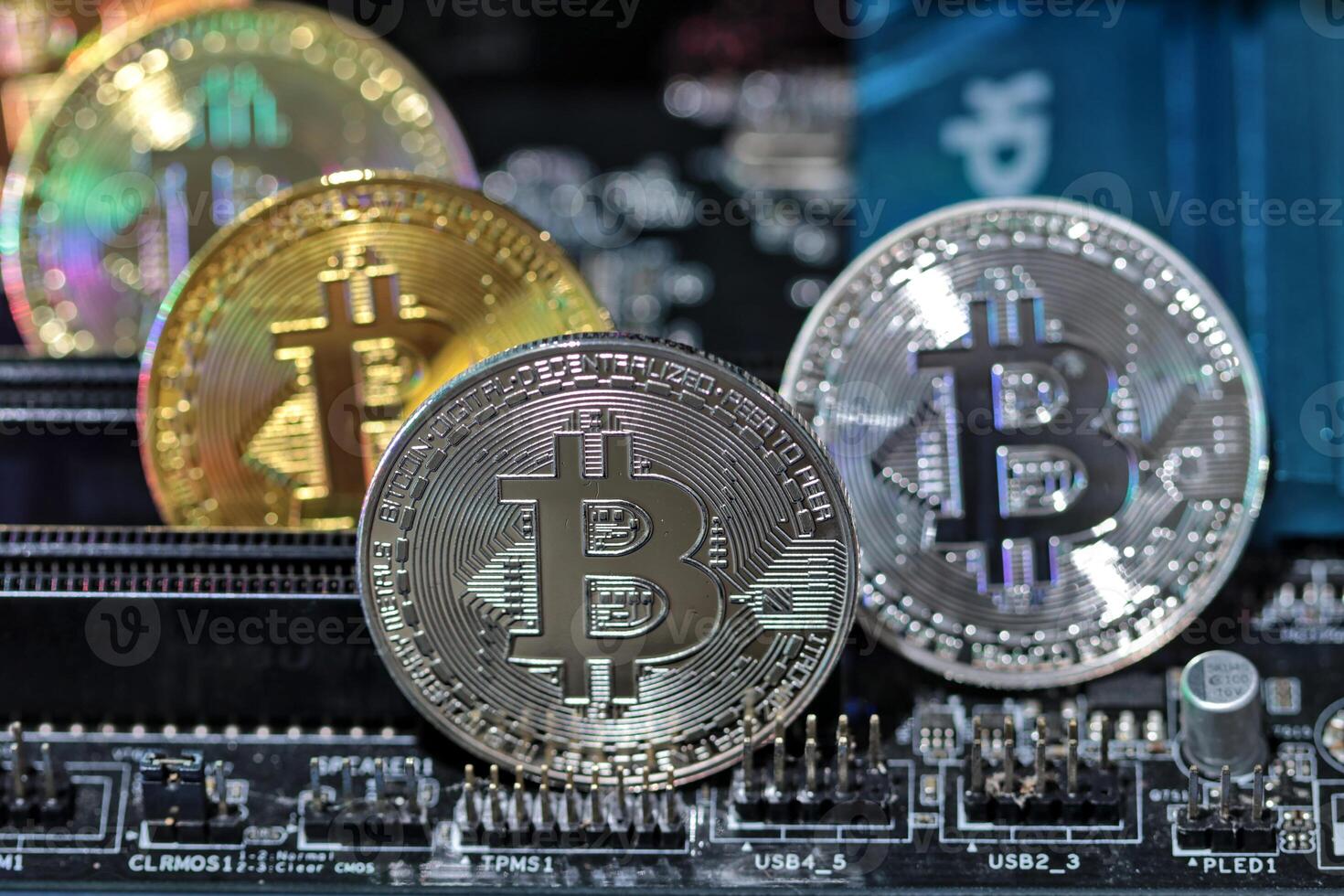 Bitcoin coins on computer equipment The concept of digital coin prices goes down and stops mining. photo