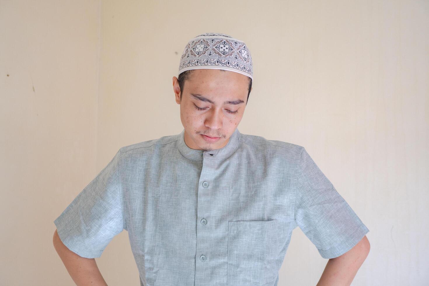 Moslem Asian man sad gesture when Ramadan celebration. The photo is suitable to use for Ramadhan poster and Muslim content media.