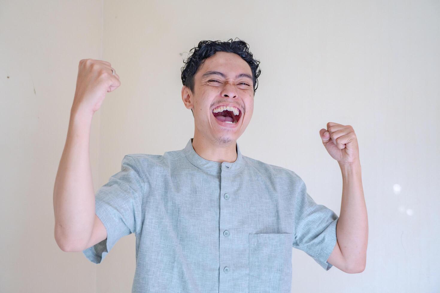 Moslem Asian man celebration pose when Ramadan celebration. The photo is suitable to use for Ramadhan poster and Muslim content media.