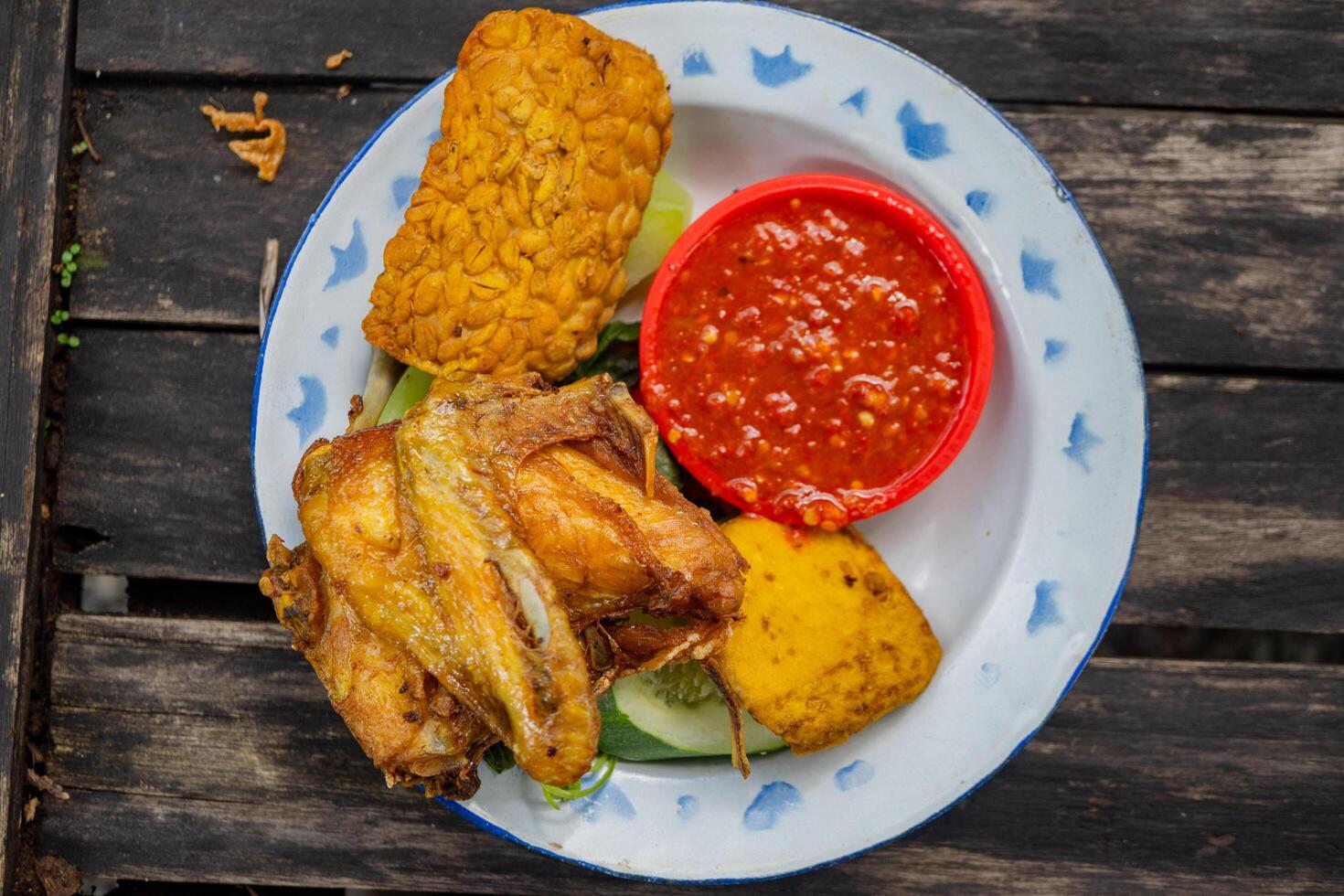 Traditional food of Javanese chicken, tofu, tempe and chili sauce. The photo is suitable to use for traditional food background and snack content media