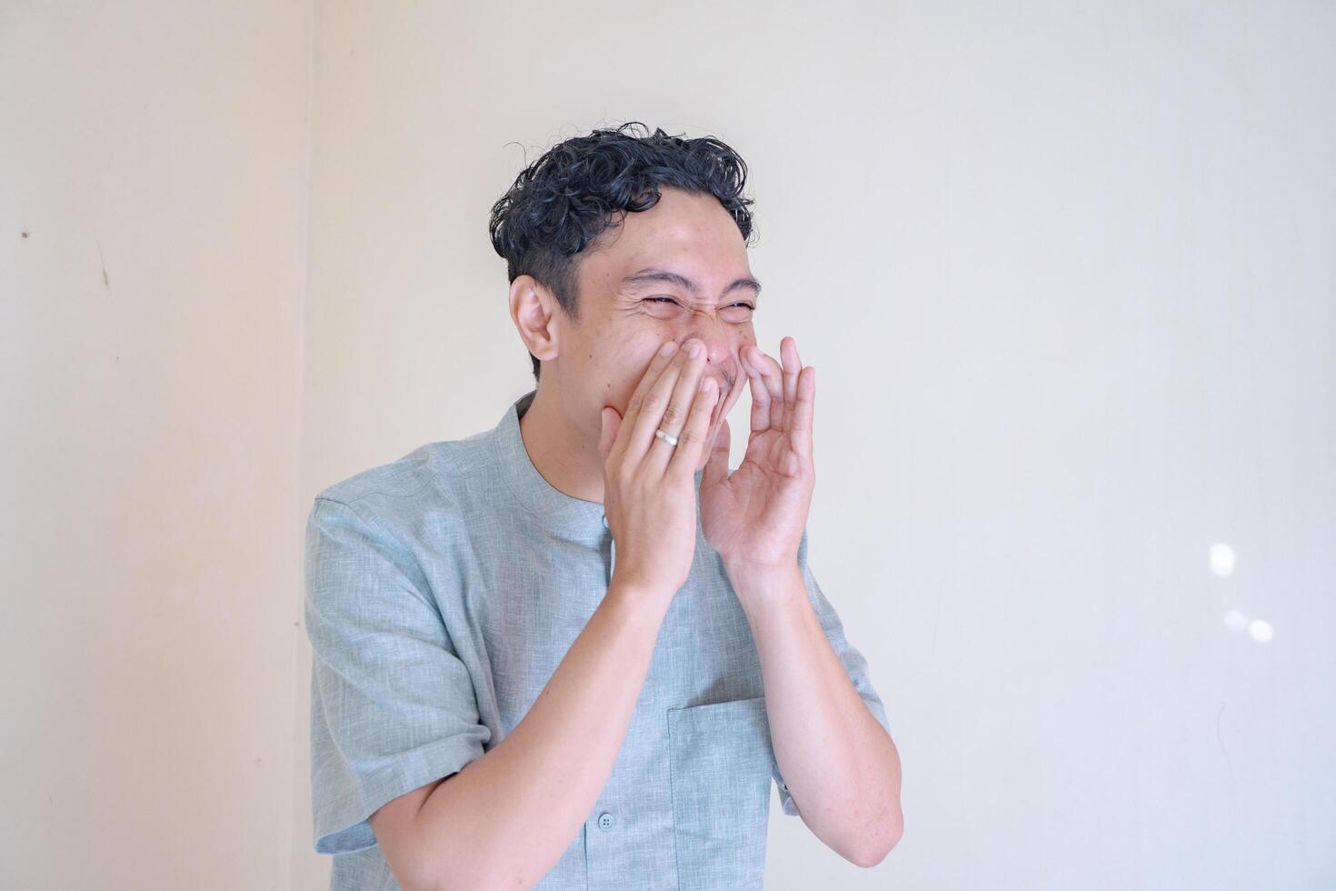 Moslem Asian man shouting and screaming gesture when Ramadan celebration. The photo is suitable to use for Ramadhan poster and Muslim content media.