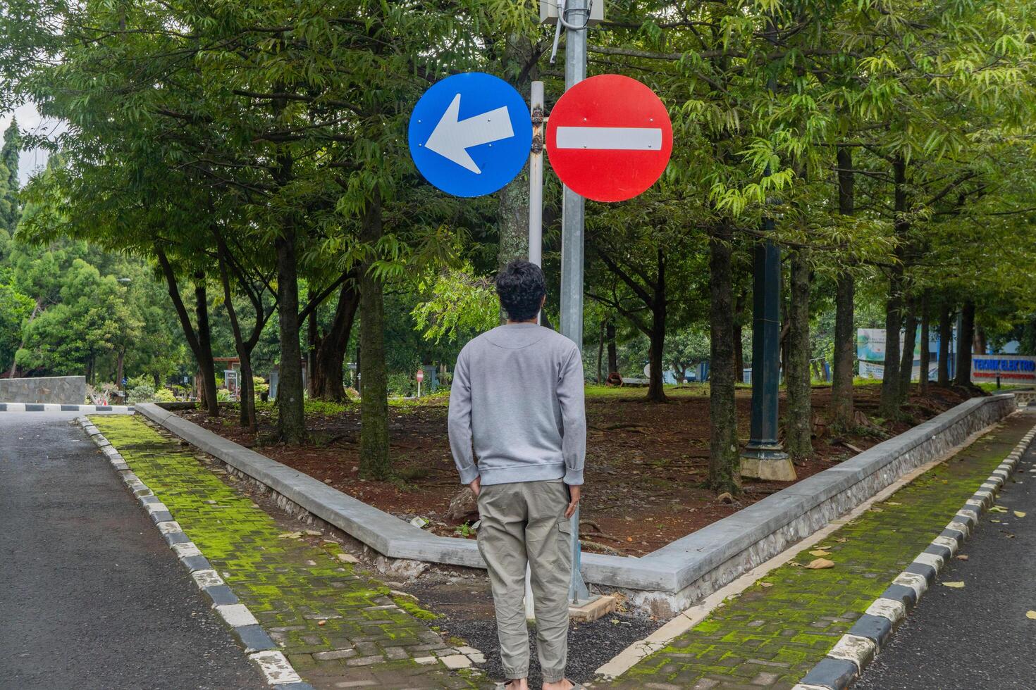 Man look to the sign direction traffic. The photo is suitable to use for adventure and travel destination content media.