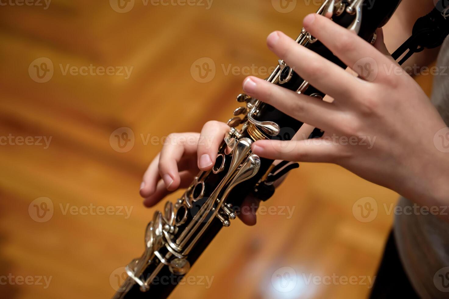 Close up of children's hands playing the clarinet in a music studio photo