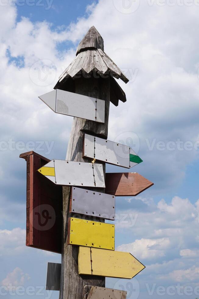 Wooden Signpost with Many Arrows photo