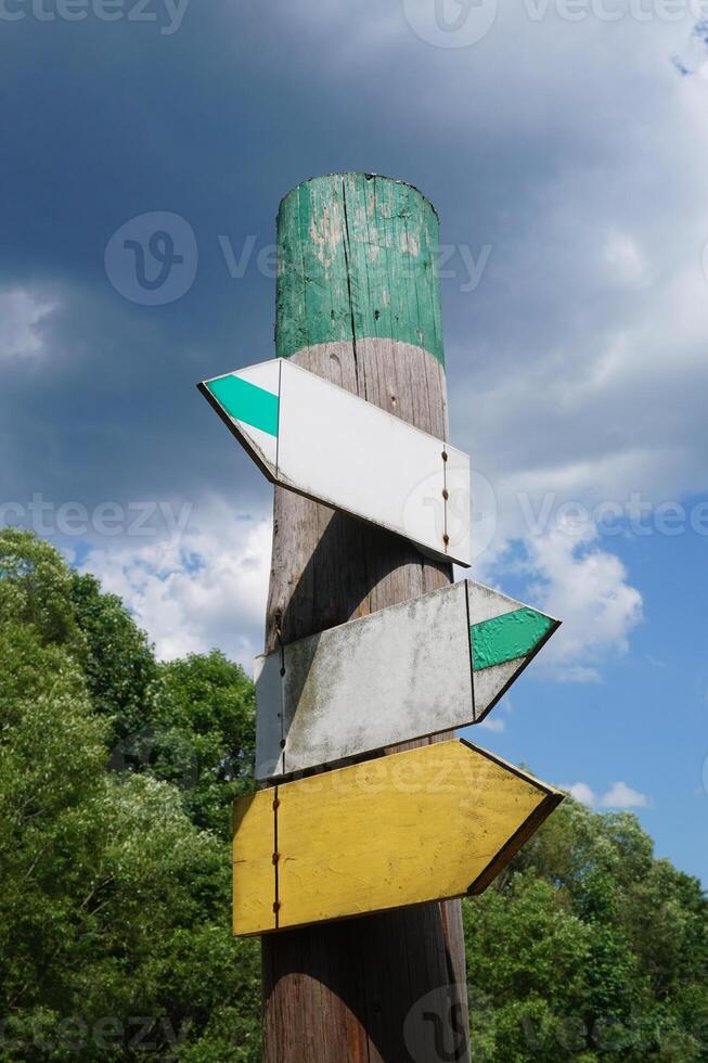 Wooden signpost with Three Arrows photo