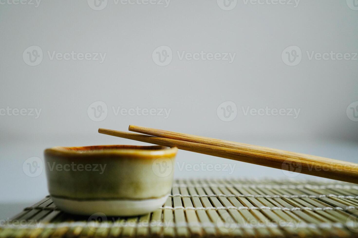 chopsticks and bowl of soy sauce photo