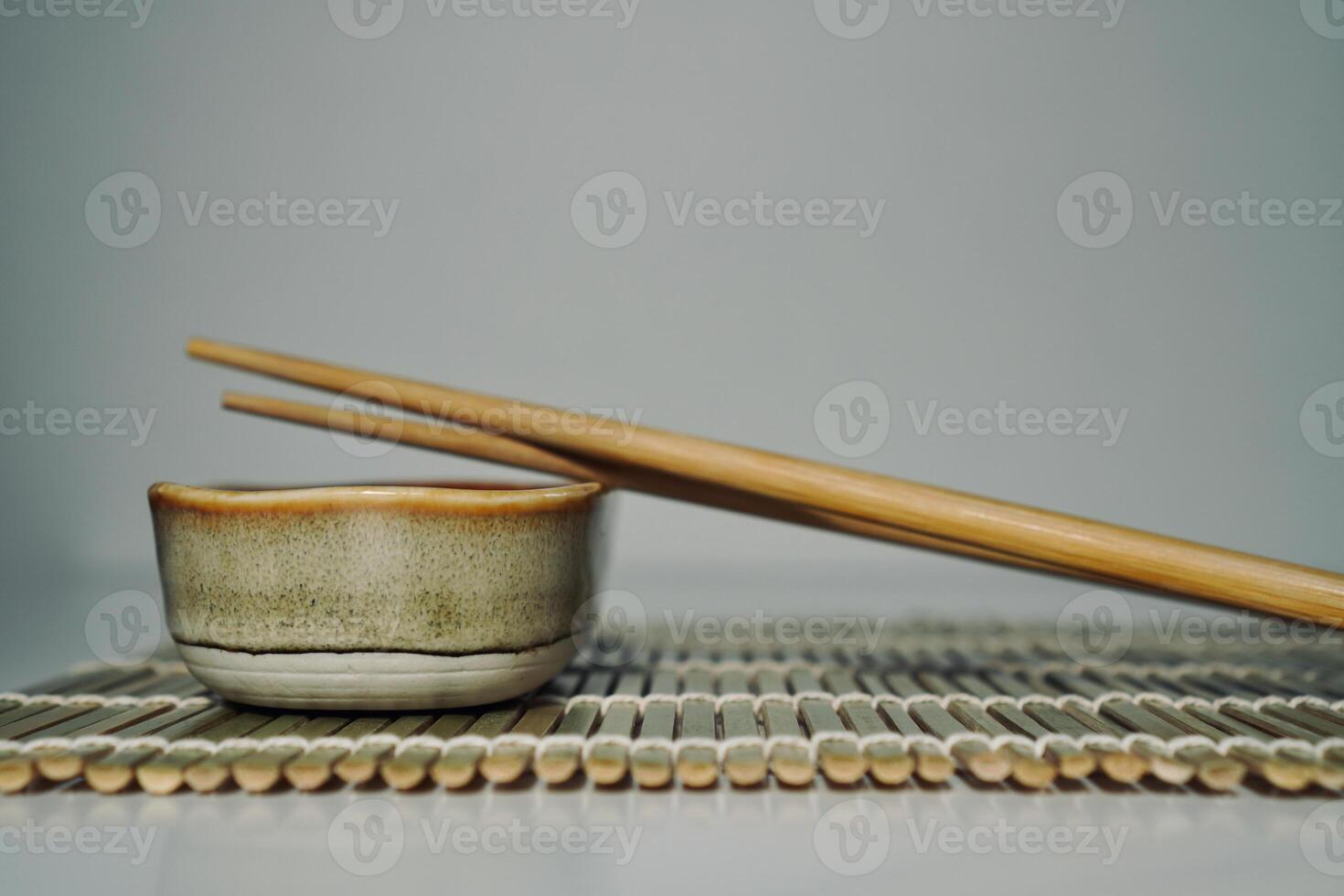 chopsticks and bowl of soy sauce photo