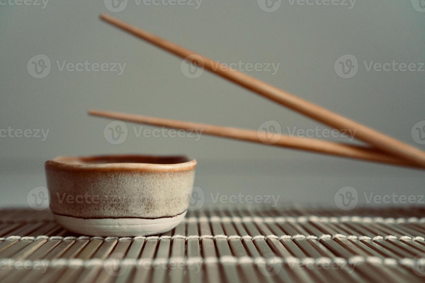 chopsticks and bowl of soy sauce photo