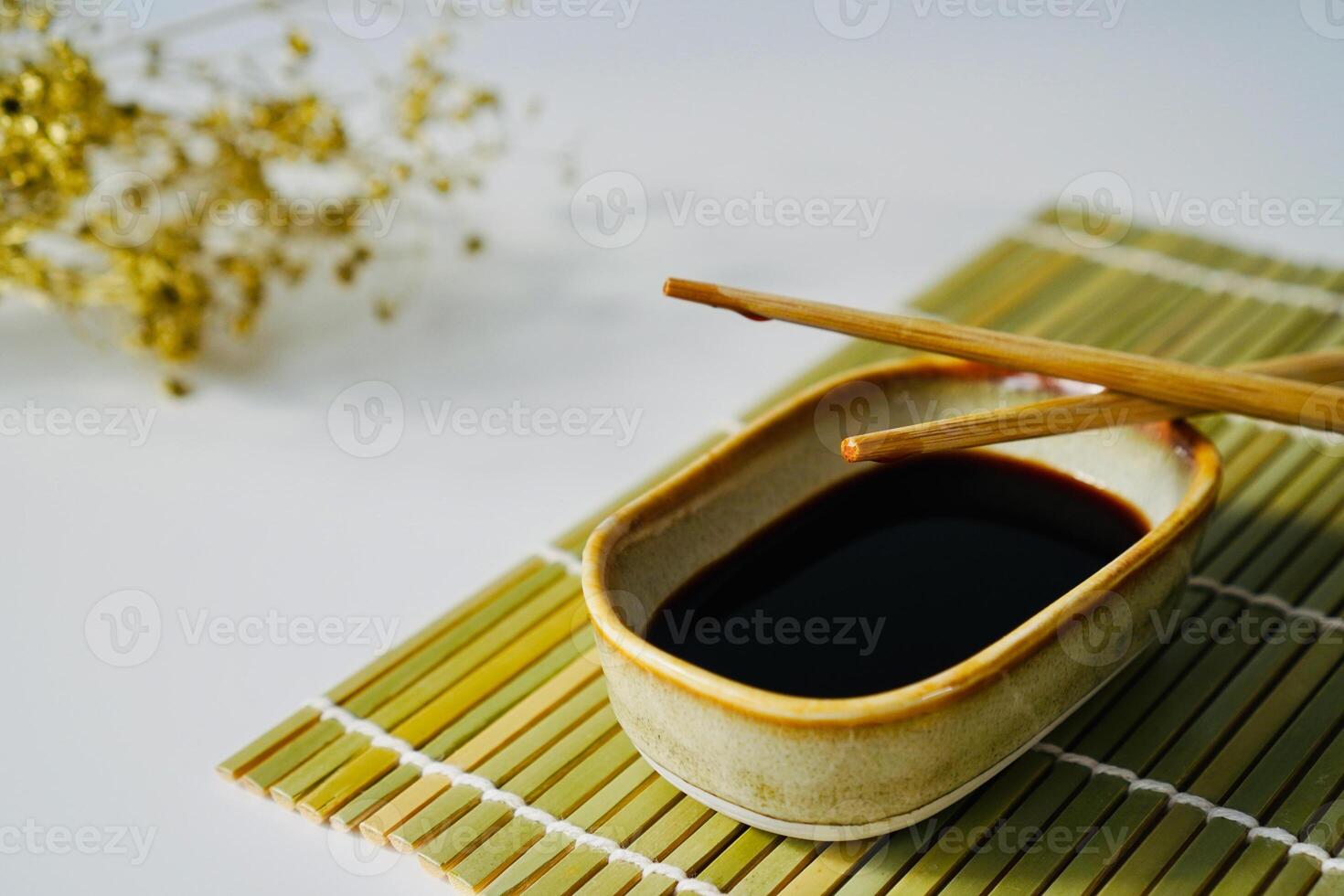 chopsticks and bowl of soy sauce photo