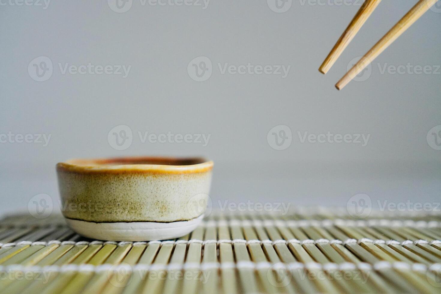 chopsticks and bowl of soy sauce photo
