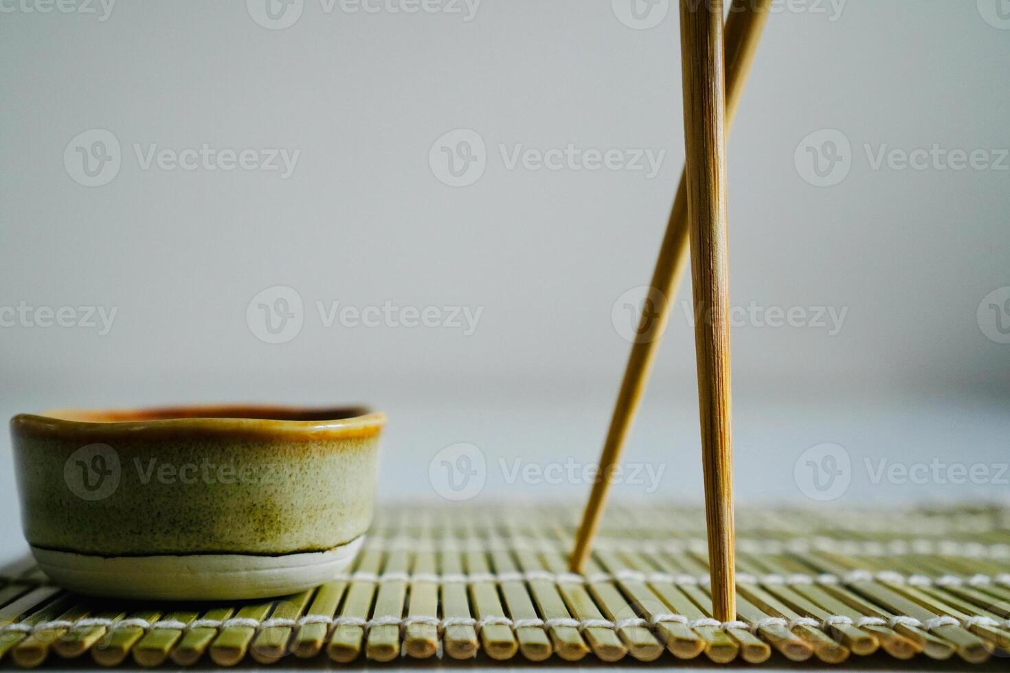 chopsticks and bowl of soy sauce photo