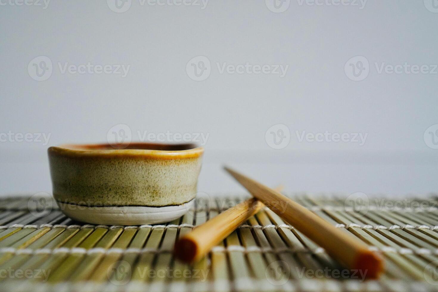 chopsticks and bowl of soy sauce photo