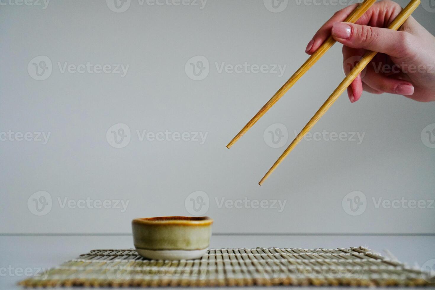 chopsticks and bowl of soy sauce photo