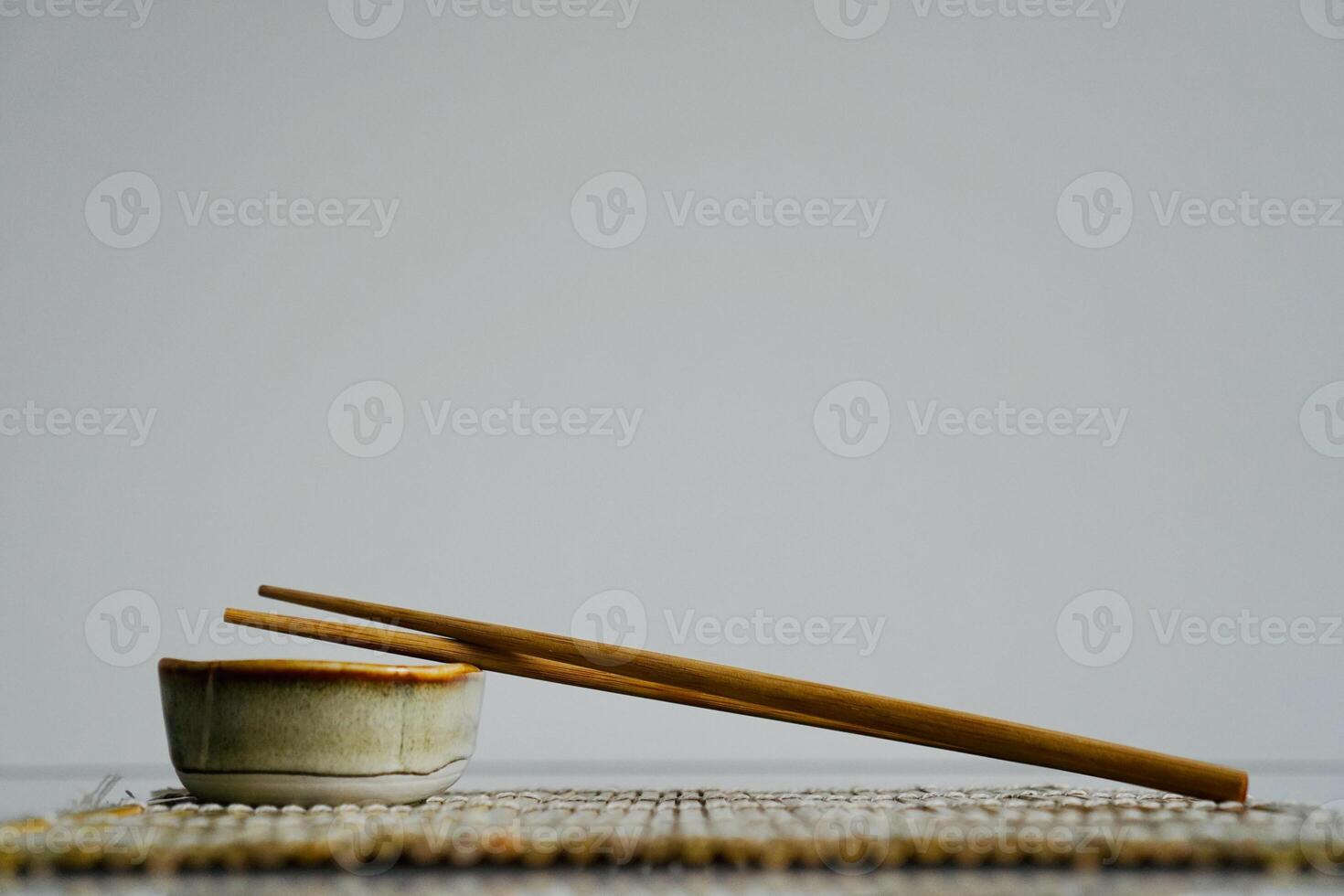 chopsticks and bowl of soy sauce photo